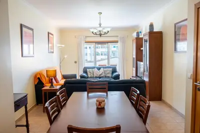 a living room with a table and a couch at Central 2 Beedroms Old Tow Apartment in Albufeira