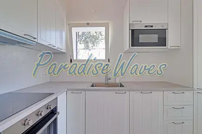 a white kitchen with a sink and a microwave at Apartment Ouramar - 550 meters from de beach in Albufeira