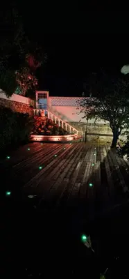 a wooden boardwalk with a beach at night at Villa Saromani in Branqueira