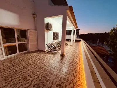 a balcony of a house with chairs on it at Villa Saromani in Branqueira
