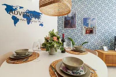 a living room with a couch and a kitchen at São Luís Faro Apartment - Algarve in Faro