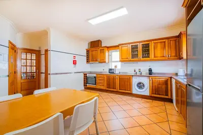 a kitchen with a table and a refrigerator at Villa Okapi by Atlantic Places in Albufeira