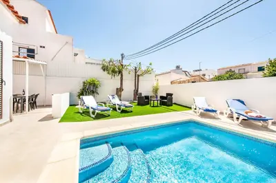 a swimming pool in the backyard of a house at Villa Dela in Galé