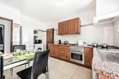 a kitchen with wooden cabinets and a counter top at Villa Dela in Galé