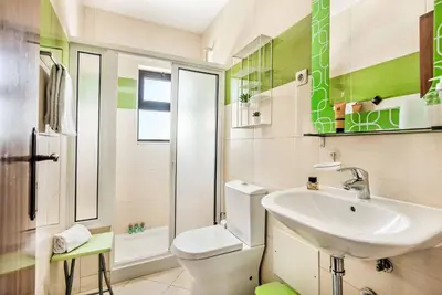 a bathroom with a white toilet and a sink at Villa Dela in Galé