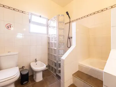 a bathroom with a toilet and a tub and a sink at Akivillas Loulé Holiday in Espargal