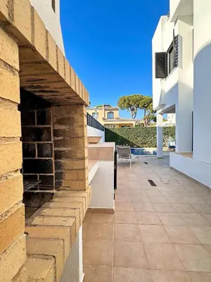 a building with a brick wall and a patio at Villa Brasil by BeCherish in Quarteira