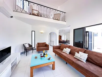 a living room with a couch and a table at Villa Brasil by BeCherish in Quarteira