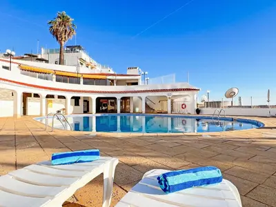 a white dining room with a table and chairs at Breathtaking Ocean & City Views by BeCherish in Albufeira