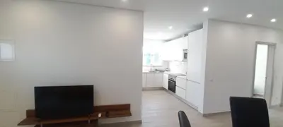 a small kitchen with white cabinets and a sink at Almancil Residence in Almancil