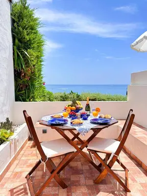 a table with plates of food on a patio at Charming AlgarvianOceanfront Townhouse by BeCherish in Albufeira