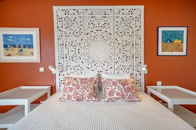 a bedroom with a bed with a white headboard at Angela's in Albufeira