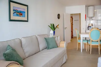 a living room with a couch and a dining room at Angela's in Albufeira