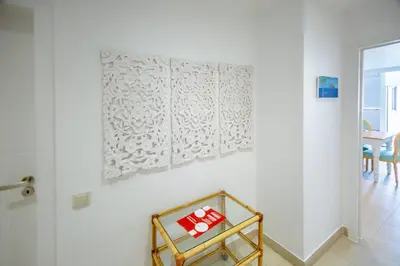 a room with a white wall with a picture on the wall at Angela's in Albufeira
