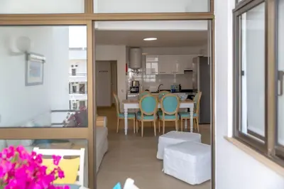 a kitchen and dining room with a table and chairs at Angela's in Albufeira