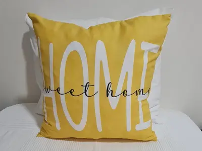 a yellow pillow with the words momnt home mum at Sunbeam Home - Albufeira in Albufeira