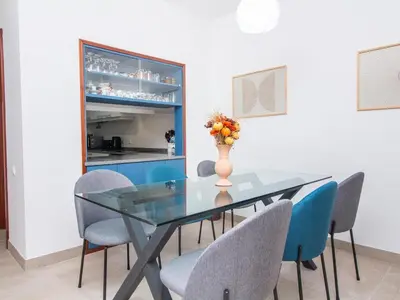 a dining room with a glass table and chairs at Balaia Praia Apartment by Stay ici Algarve Holiday Rental in Albufeira