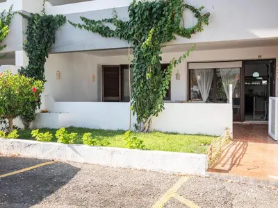a white house with ivy on the facade at Balaia Praia Apartment by Stay ici Algarve Holiday Rental in Albufeira