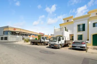three cars parked in a parking lot in front of a building at Mae Joana pool&beach Faro villa in Faro