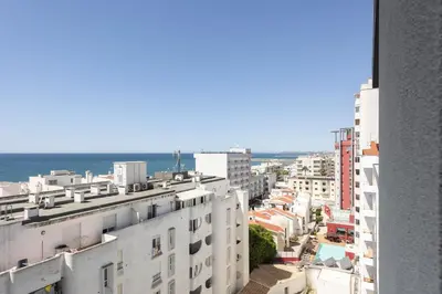 a view of a city with buildings and the ocean at Terracos de Quarteira II Cherry by Real Properties in Quarteira