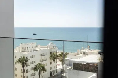 a view of the ocean from the balcony of a building at Terracos de Quarteira II Cherry by Real Properties in Quarteira