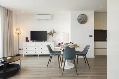 a dining room with a table and chairs at Terracos de Quarteira II Cherry by Real Properties in Quarteira