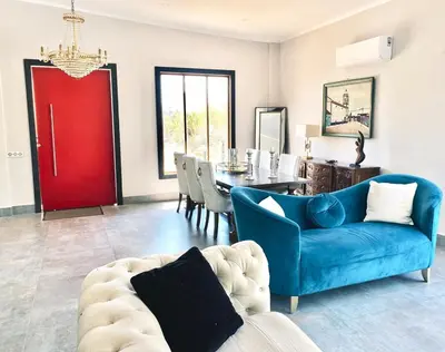 a living room with a blue couch and a red door at Country villa in Algarve, 15 min from beach in Albufeira