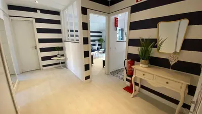 a hallway with black and white striped walls and a mirror at Blue Beach Home with Terrace in Albufeira