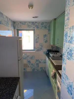 a kitchen with green and blue tiled walls and a refrigerator at Marina Pool & Sea in Albufeira