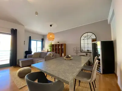 a kitchen and living room with a table and chairs at Marina Pool & Sea in Albufeira