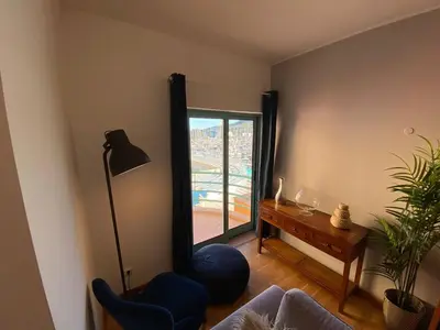 a living room with a couch and a table and a window at Marina Pool & Sea in Albufeira
