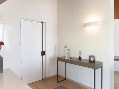 a room with a table and a white wall at Premium Apartment with Vilamoura Marina View in Vilamoura