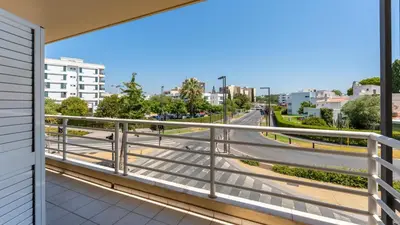 a balcony with a view of a street at Cozy 1Bdr Flat w Pool in Vilamoura by Lovelystay in Quarteira