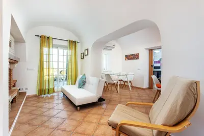 a living room with white furniture and a table at Blife Moustachya Villa in Faro