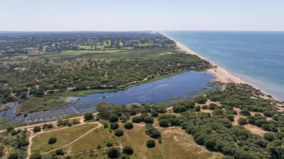 an aerial view of a beach and a body of water at Cavalo Preto Ocean Breeze Apartment in Forte Novo Quarteira in Quarteira