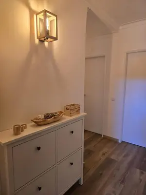 a room with a dresser and a light on the wall at CityComfort in Faro