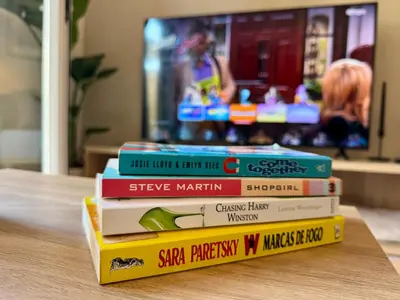 a stack of books sitting on top of a table at Cosy 1-Bedroom Apartment with Private Terrace in Loulé in Loulé