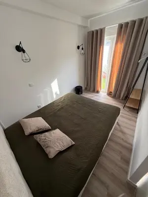 a bedroom with a large bed with two pillows on it at Camilas Place 2 in Bicas