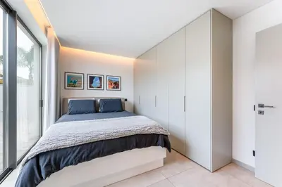 a bedroom with a bed and a large window at Villa Memorias by Algarve Holidays in Páteo