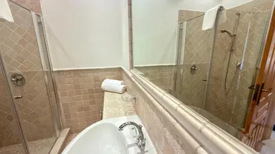 a bathroom with a shower and a sink and a mirror at Belinha - PINHEIROS ALTOS in Ludo