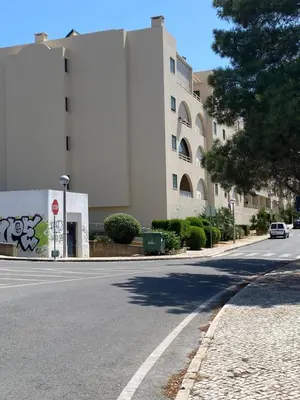 an empty street in front of a large building at Salgados Village, Santos Apartment in Guia