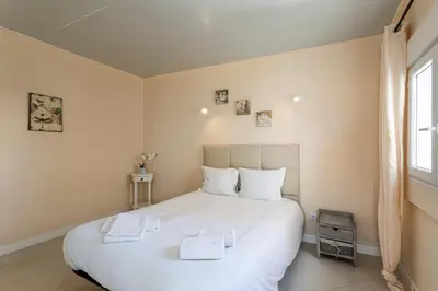 a bedroom with a large white bed with two towels on it at Budget Beach Center B5 in Albufeira