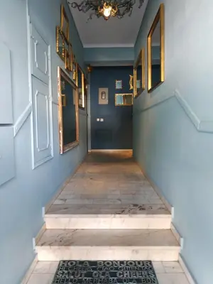 a hallway with blue walls and stairs with a chandelier at 150m to the beach at Sol a Sul apartments in Albufeira