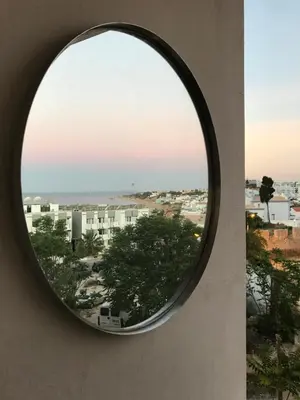 a round window with a view of a city at 150m to the beach at Sol a Sul apartments in Albufeira