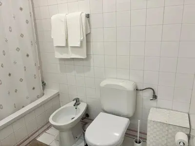 a white phone on a wall in a bathroom at Aqualux Golden Sun Amazing Holiday in Albufeira