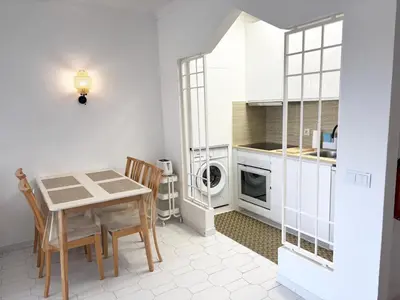a living room with a blue couch and a kitchen at Aqualux Golden Sun Amazing Holiday in Albufeira