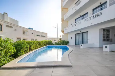 a swimming pool in the courtyard of a building at Stunning Ocean View Apt Beach 200mt AC Pool in Albufeira