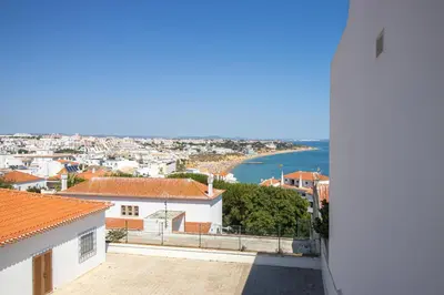 a view of the ocean from the balcony of a house at Stunning Ocean View Apt Beach 200mt AC Pool in Albufeira