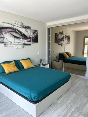a bedroom with a large bed with blue sheets at Luxury home in Albufeira in Albufeira