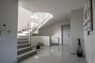 a hallway with a spiral staircase in a house at Luxury home in Albufeira in Albufeira